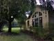 Attractive home exterior with arched windows, professional landscaping, and mature trees at 406 Petrel Trl, Bradenton, FL 34212