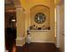 Inviting foyer with elegant decor, featuring wood floors, arched entryway, and decorative niche at 406 Petrel Trl, Bradenton, FL 34212