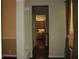 Hallway leading to the kitchen with wood cabinets and granite countertops at 406 Petrel Trl, Bradenton, FL 34212
