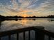 Serene lake view with sunset reflecting on the water, capturing the property's tranquil setting at 406 Petrel Trl, Bradenton, FL 34212