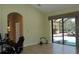 Bright living room with access to the screened-in lanai and views of the outdoor pool area at 406 Petrel Trl, Bradenton, FL 34212