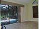 Bright living room with a tile floor, screened-in lanai access, and a view of the pool area at 406 Petrel Trl, Bradenton, FL 34212