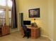 Cozy home office with a wooden desk, ample storage, and natural light from large windows at 406 Petrel Trl, Bradenton, FL 34212