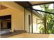 Covered outdoor kitchen with a built-in grill and sink, seamlessly blending indoor and outdoor living at 406 Petrel Trl, Bradenton, FL 34212