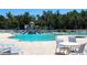 Community pool area with lounge chairs, tables, and a splash pad at 406 Petrel Trl, Bradenton, FL 34212