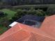 Aerial view of a screened-in pool and brick-tiled roof, offering privacy and outdoor relaxation at 406 Petrel Trl, Bradenton, FL 34212