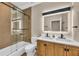 A bathroom with a glass shower, dark hardware, and a light-up vanity mirror at 4153 Camino Real, Sarasota, FL 34231