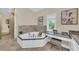 Bright bathroom featuring a garden tub with marble accents, vanity and modern design at 4153 Camino Real, Sarasota, FL 34231