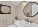 Charming powder room with decorative mirror, pedestal sink, and elegant fixtures at 4153 Camino Real, Sarasota, FL 34231