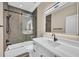 A bathroom with a glass shower, black hardware, and a light-up vanity mirror at 4153 Camino Real, Sarasota, FL 34231