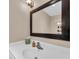 Bathroom with a white sink, decorative mirror and good lighting at 4153 Camino Real, Sarasota, FL 34231
