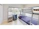 Charming bedroom with bunk beds, light wood floors, and a bright window at 4153 Camino Real, Sarasota, FL 34231