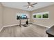 Versatile bedroom with natural light and wood-look floors, perfect for work or relaxation at 4153 Camino Real, Sarasota, FL 34231
