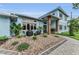 A beautiful two-story house featuring stone accents, decorative rocks, and desert landscaping at 4153 Camino Real, Sarasota, FL 34231