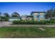 Charming two-story home with manicured landscaping, stone accents, and a paver driveway at 4153 Camino Real, Sarasota, FL 34231