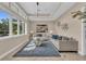 Bright living room with large windows, stylish decor, and modern furnishings creating an inviting space at 4153 Camino Real, Sarasota, FL 34231