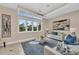 Inviting living room featuring high windows, recessed lights, stylish furniture, and a modern chandelier at 4153 Camino Real, Sarasota, FL 34231