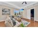 Elegant living room featuring a plush sectional sofa, coffered ceiling, and modern decor at 4153 Camino Real, Sarasota, FL 34231
