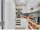 Well-organized pantry features custom shelves and ample storage space for all your groceries at 4153 Camino Real, Sarasota, FL 34231