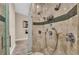 Luxurious walk-in shower with multiple showerheads and decorative tile accents at 4153 Camino Real, Sarasota, FL 34231