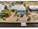 Aerial view of a home with a large pool, screened lanai, and dock access to the canal at 4219 Eastlake Ct, Port Charlotte, FL 33948