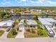 Aerial view of canal front home with lush landscaping and beautiful surroundings in a waterfront community at 4219 Eastlake Ct, Port Charlotte, FL 33948