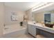 Relaxing bathroom with a soaking tub and vanity area, enhanced by tasteful decorations and soft lighting at 4219 Eastlake Ct, Port Charlotte, FL 33948