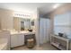 Well-lit bathroom featuring a shower with a vanity area, ample counter space, and a stool at 4219 Eastlake Ct, Port Charlotte, FL 33948