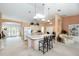 Open kitchen with an island and barstool seating, offering a view of the living area and outdoor space at 4219 Eastlake Ct, Port Charlotte, FL 33948