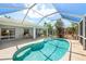 Beautiful screened pool with clear blue water and covered patio at 4219 Eastlake Ct, Port Charlotte, FL 33948