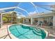 Beautiful screened pool with clear blue water, covered patio, and lots of outdoor space to enjoy at 4219 Eastlake Ct, Port Charlotte, FL 33948
