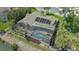 Aerial view showcasing the backyard pool, lush landscaping, and tile roof at 452 Picasso Dr, Nokomis, FL 34275