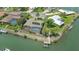 Aerial view displaying waterfront home with screened pool, dock, and mature landscaping at 452 Picasso Dr, Nokomis, FL 34275
