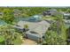Aerial view of a well-maintained home with lush landscaping, private boat dock, and water access at 452 Picasso Dr, Nokomis, FL 34275