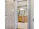 Hallway view into the bathroom featuring a light wood vanity at 452 Picasso Dr, Nokomis, FL 34275