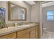 Bathroom featuring a vanity with light wood cabinets and a large mirror at 452 Picasso Dr, Nokomis, FL 34275