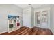 Bedroom view featuring a white shelving unit and hardwood flooring at 452 Picasso Dr, Nokomis, FL 34275