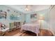 Bright bedroom with a bed, desk, bookshelf, and window for natural light and wood floors at 452 Picasso Dr, Nokomis, FL 34275
