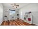 Bright bedroom with a ceiling fan, hardwood floors, and a white writing desk at 452 Picasso Dr, Nokomis, FL 34275
