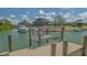 Private boat lift offering convenience for waterfront living with lush landscaping in background at 452 Picasso Dr, Nokomis, FL 34275