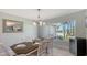 Dining area with ample natural light, showcasing the table setting and stylish decor at 452 Picasso Dr, Nokomis, FL 34275
