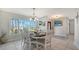 Bright dining room with a large window offering views and elegant chandelier lighting at 452 Picasso Dr, Nokomis, FL 34275