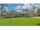 Charming single-story home with a well-manicured lawn and mature palm trees at 452 Picasso Dr, Nokomis, FL 34275