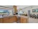 Bright, open kitchen with stainless appliances and views to the pool and living area at 452 Picasso Dr, Nokomis, FL 34275