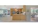 Kitchen features stainless steel appliances and views to the pool and dining areas at 452 Picasso Dr, Nokomis, FL 34275