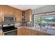 Bright kitchen with natural wood cabinetry and views of the backyard waterway at 452 Picasso Dr, Nokomis, FL 34275