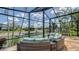 Relaxing lanai with seating area overlooking canal and boat dock with lush landscape at 452 Picasso Dr, Nokomis, FL 34275