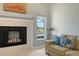 Living room with fireplace and natural light, overlooking the waterway at 452 Picasso Dr, Nokomis, FL 34275