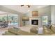 Cozy living room with fireplace, pool view, and slider doors to outdoor living at 452 Picasso Dr, Nokomis, FL 34275