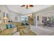 Open-concept living area with tile flooring and views of the kitchen and pool area at 452 Picasso Dr, Nokomis, FL 34275